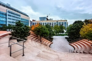Outdoor amphitheater and campus buildings surrounded by trees at a Nevada college campus — ideal for a tour of top colleges in Nevada.