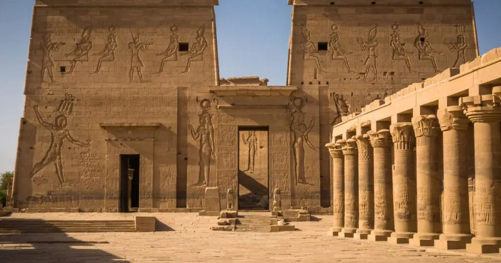 Ancient Egyptian temple with carved hieroglyphics and massive stone columns.