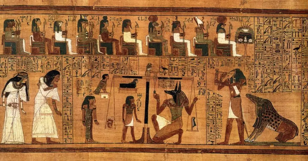 The scene features Anubis, the god of mummification, performing the judgment of the deceased, where their heart is weighed against the feather of Ma'at, symbolizing truth. Surrounding Anubis are various deities and scribes, and the hieroglyphs convey the spiritual process in the afterlife.